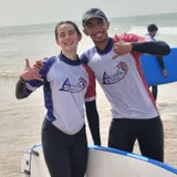 Solo surf student with coach Simo on Agadir Beach